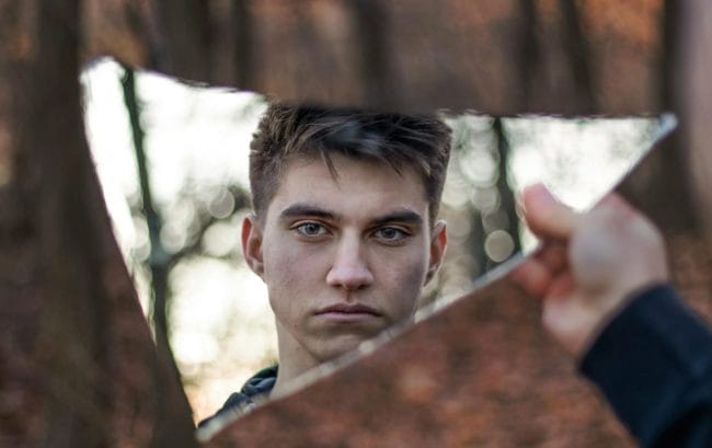 Man Looking In Mirror
